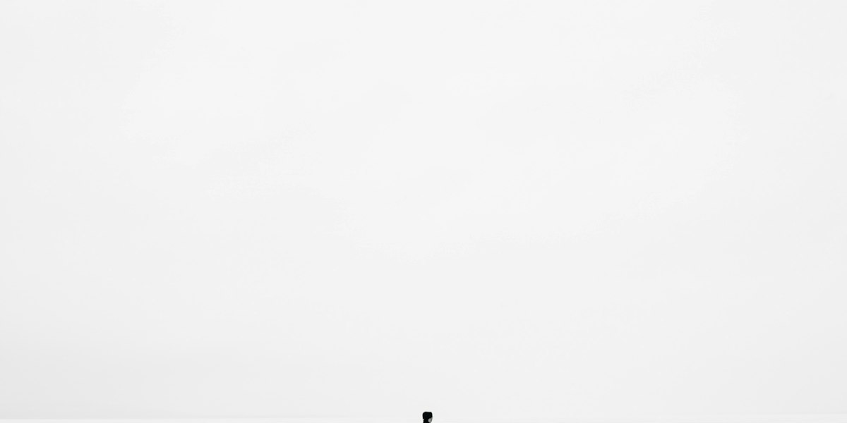 Silhouette marchant sur étendue blanche, minimalisme